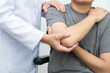 © manassanant - Physical therapy, Asian therapist doctor treat perform pain young man in hospital.
