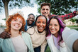 © Jose Calsina - Group of happy teenagers smiling and having fun outdoors, enjoying friendship and diversity while taking a selfie together in a park on a bright sunny day. Young friends smiling and laughing