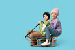 © Pixel-Shot - Cute little children in warm winter clothes with sledge on blue background