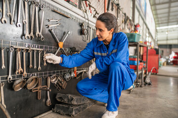 Wall Mural - Female Auto mechanic are checking and repair maintenance auto engine is problems at car repair shop.