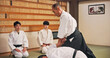 © peopleimages.com - Karate, martial arts and self defense with Sensei in dojo for challenge, fitness or training. Demonstration, grappling or technique with instructor and student people in Japan for combat, fighting