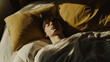 © Niams Haus - Person lying in bed with troubled expression, eyes closed, surrounded by soft pillows, symbolizing sleep disorder and restlessness.