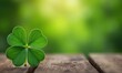 © Vitaliy - Green clover leaf with four ends lies on wooden table. Clover leaf is symbol of good luck and protection