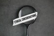 © Fauzi - magnifying glass and a white sticker with the words Ethical considerations. principles that inform research methods and designs.