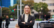 © peopleimages.com - Business woman, arms crossed and portrait in city with smile, travel and pride for career in street. Person, happy and outdoor with confidence, excited or urban sidewalk for commute to work in Japan