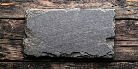 Poster - Empty stone board resting on a wooden background offers ample copy space. The stone board provides a unique texture, enhancing any creative project with its simplicity and elegance for copy space.