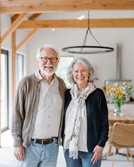 Loving senior couple embracing and smiling in their cozy new home, happy older man and woman celebrating life's joyful moments together in retirement and aging gracefully 