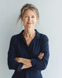 © Colors of Earth Co. - Confident mature blonde businesswoman entrepreneur with arms crossed, successful older female executive in bright office workspace business portrait