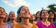 © Tadeusz - Group of diverse women smiling with joy during a sunny outdoor event.