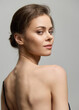 © SHOTPRIME STUDIO - Elegant young woman gazing back over her shoulder, showcasing a graceful pose and soft facial expression. Beauty and confidence concept.