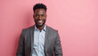 © Nadiya - Cheerful young black man in a suit smiling against a pink background