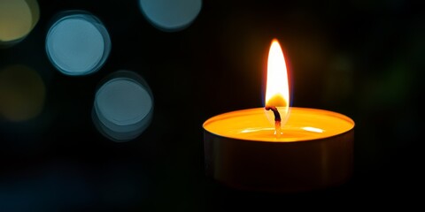 Aufkleber - Candle light illuminates a dark background, creating a warm and serene atmosphere. The soft glow of candle light enhances the mood and adds a touch of elegance to any setting.