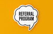 © fitpinkcat84 - Referral program concept written in a speech bubble. Yellow background, illustration.