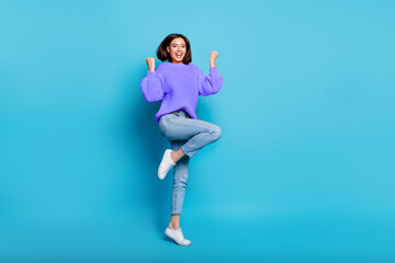 Wall Mural - Full length body size view of attractive cheerful lucky girl jumping dancing rejoicing isolated over bright blue color background