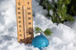 © Elena - Christmas toy ball near tree and thermometer on natural snow in winter forest. Weather forecast for New Year and Christmas holidays. Frosty sunny day for happy free time in nature outdoor