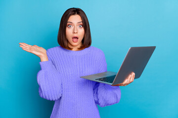 Wall Mural - Portrait of attractive amazed clueless girl using laptop new web offer isolated over bright blue color background