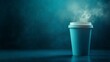 © hamzahalderad - A steaming cup of coffee on a dark blue background.