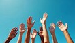 © Vintage Stock - Diverse Group Of Hands Raised Against Clear Blue Sky