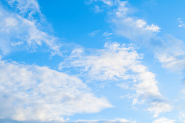 Wall Mural - pictorial blue cloudy sky landscape, blue sky landscape scene with cumulus fluffy clouds lit by suns