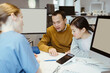 © Maskot - Father and daughter going through medical reports and discussing with doctor at hospital