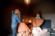 © Maskot - Father and son playing with blanket in bedroom at home