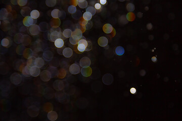 abstract bokeh lights with colorful circles on dark background, creating a dreamy and festive atmosp