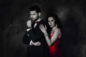 Aufkleber - Portrait of charming pretty beautiful lady with curls looking at camera hugging ponder minded man in suit tux with bow expensive watch isolated on dark grey background