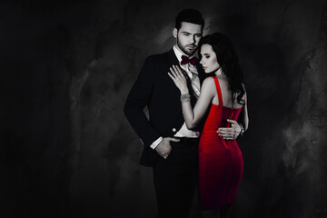 Poster - Portrait of brutal mr with bristle in tux with bow holding hand in pocket of pants embracing pretty charming mrs with booty bum isolated on grey background with copy space empty place