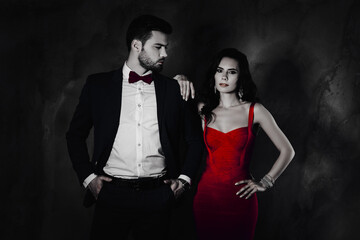 Aufkleber - Profile portrait of virile cool mr in blue tux with bow holding two hands in pants looking at his charming brunette mrs with jewerly in lilac dress isolated on dark grey background