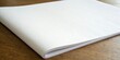 © Theerawat - A stack of blank white paper sheets rests on a wooden surface