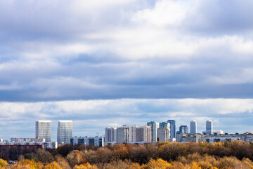 Wall Mural - low dark blue cloudy sky over colorful city park