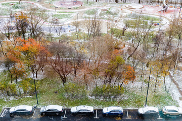 Wall Mural - cars near sport playground covered by first snow
