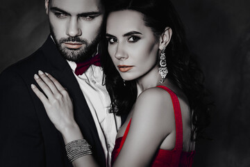 Poster - Cropped close up portrait of lovely romantic couple embracing, pretty charming mrs with jewelry, rich confident mr with stubble isolated on grey background