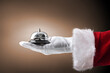 © Davizro Photography - Christmas holiday concept in hotel with Santa hand with bell