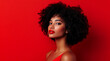 © Inspire Shots Hub - Portrait of a confident woman with curly hair against a vibrant red background showcasing beauty and style