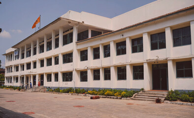 Aufkleber - Large white building with a flag on the roof. The building has many windows and a large front door
