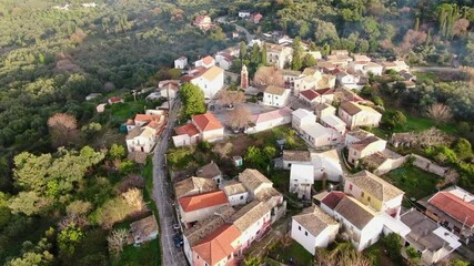 Wall Mural - Greece, mountain village Agioi douloi aerial panoramic view, Corfu. Traditional tile roof , forest trees, cloudy sunset sky, Autumn