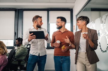 Business team discussing a project using a digital tablet in the office