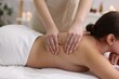© New Africa - Young woman receiving massage in spa salon
