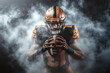 © Poj - American football player holding ball surrounded by dramatic smoke effect.