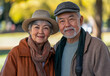 © Atmospheric stock - Elderly asian couple smiling outdoors in autumn park