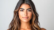 © Atmospheric stock - Young hispanic female with long hair and natural makeup smiling calmly