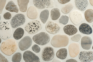 Wall Mural - Smooth pebble beach texture, rounded stones in shades of gray and beige, natural and detailed