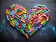 © Danicha - A Heart-Shaped Arrangement of Vibrant Colored Chalks on a Blackboard, Perfect for Creative Projects and Educational Themes