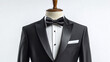 © Infinity Lens - Black tuxedo suit with bow tie and white shirt on a mannequin isolated on a white background. luxury businessman or groom clothing fashion, wedding style, elegance wear, gentleman tailor.