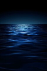 Wall Mural - deep blue ocean at night with gentle waves illuminated by moonlight on a serene and mysterious horiz