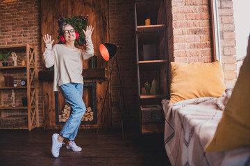 Wall Mural - Happy mature woman with grey hair enjoying leisure indoors wearing casual pullover, smiling and embracing life