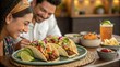 © Justlight - Diners savor gourmet tacos infused with exotic es accompanied by fresh colorful garnishes that showcase an artistic presentation.