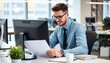© ferifadli - A handsome businessman in glasses, working on his laptop in his workspace