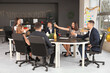 © Pixel-Shot - Group of young business people with champagne celebrating New Year at table in office